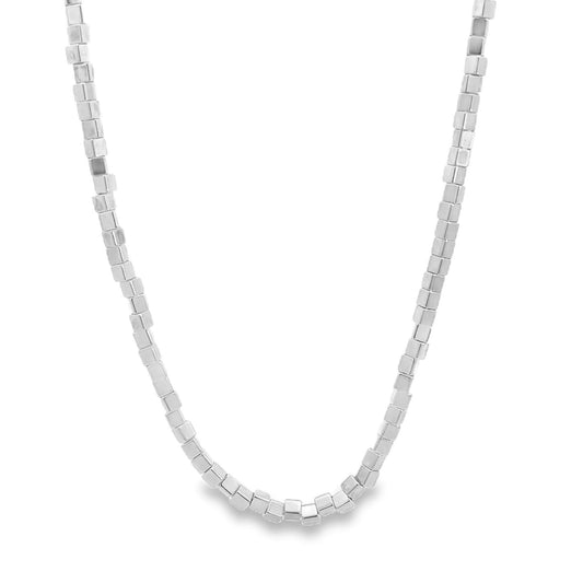 A delicate silver choker necklace features a continuous strand of tiny, polished cube beads.