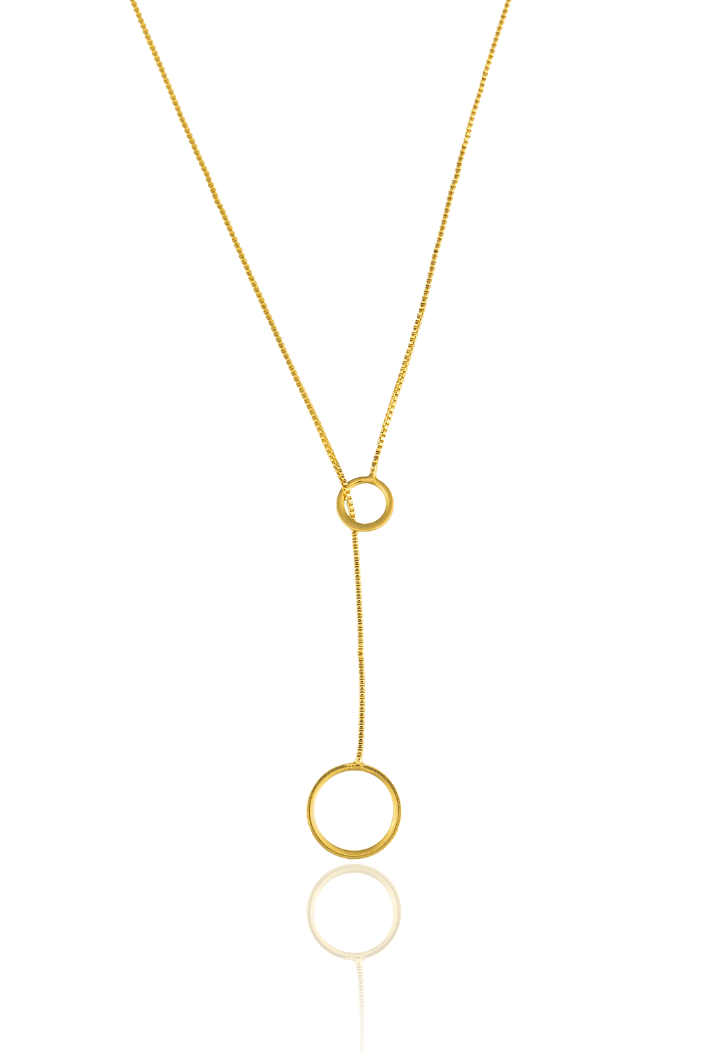 A delicate gold lariat necklace featuring two interconnected rings hangs vertically against a white background.