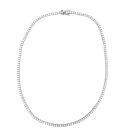 A sparkling diamond tennis necklace rests in an oval loop against a clean white background.