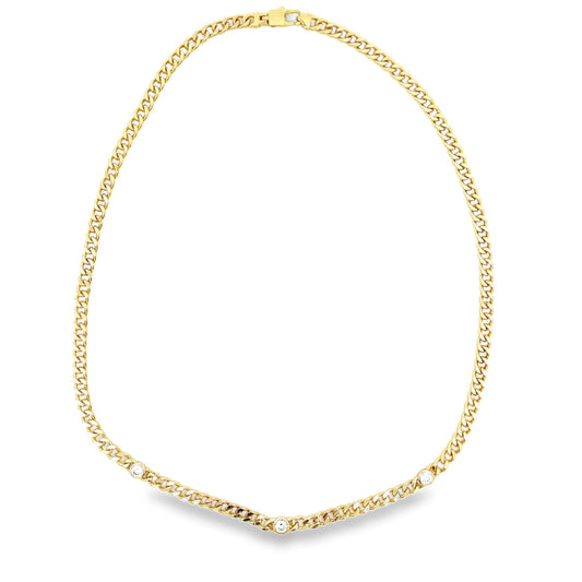 A polished gold curb chain necklace features three sparkling round-cut diamonds bezel-set along the lower links.