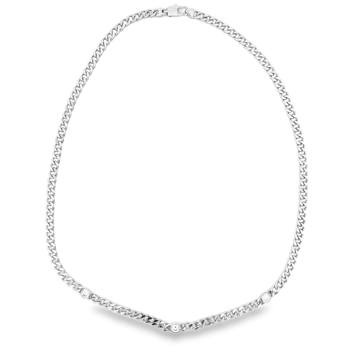 A silver cuban link chain necklace sparkles with three bezel-set diamond stones along the lower edge.