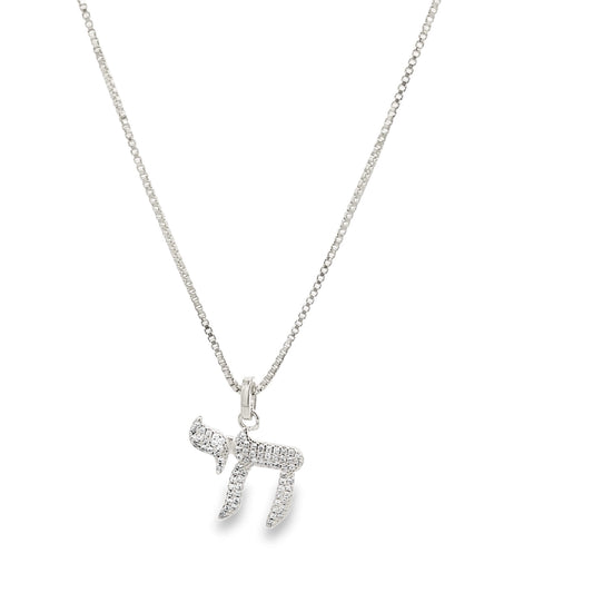 A sparkling diamond-pave Chai pendant hangs elegantly from a delicate silver box chain necklace against a white background.