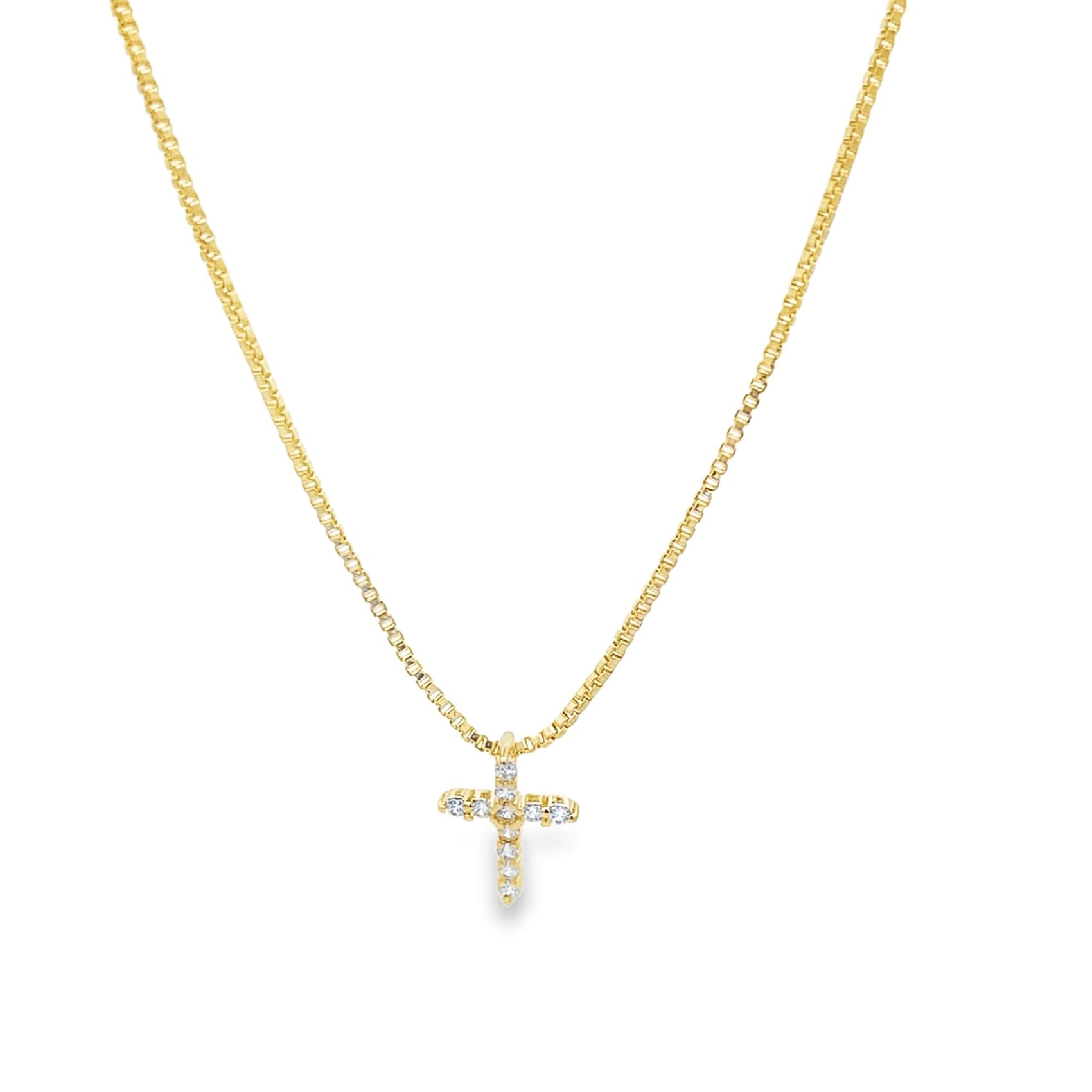 A delicate gold box chain necklace features a sparkling diamond-paved cross pendant centered against a clean white background.