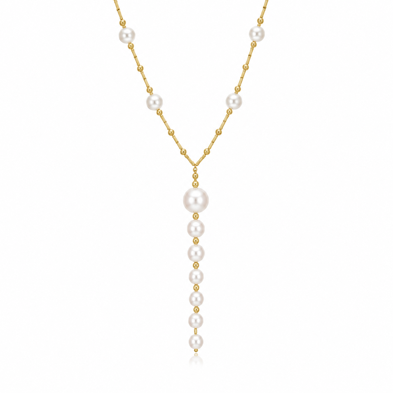 A delicate gold lariat necklace features a vertical drop of graduated white pearls interspersed with tiny gold beads against a clean white background.