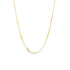 A delicate gold chain necklace with evenly spaced patterned links curves against a white background.
