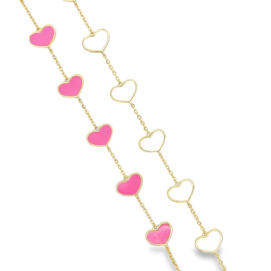 Two gold chains feature alternating pink enamel and hollow openwork heart charms against a white background.