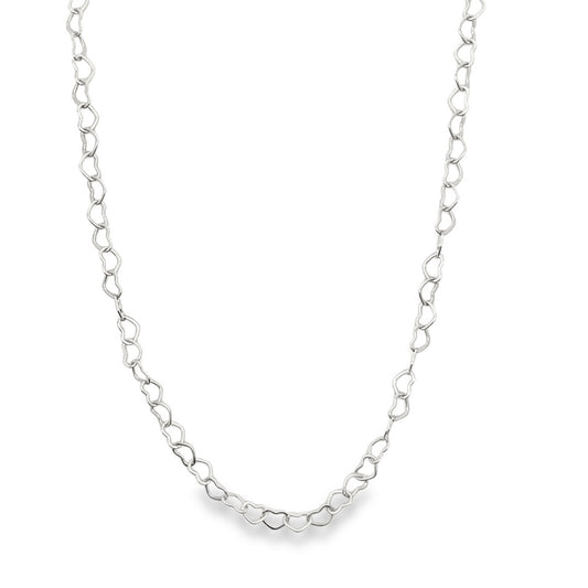 A delicate silver heart-link chain necklace rests gracefully against a white background.