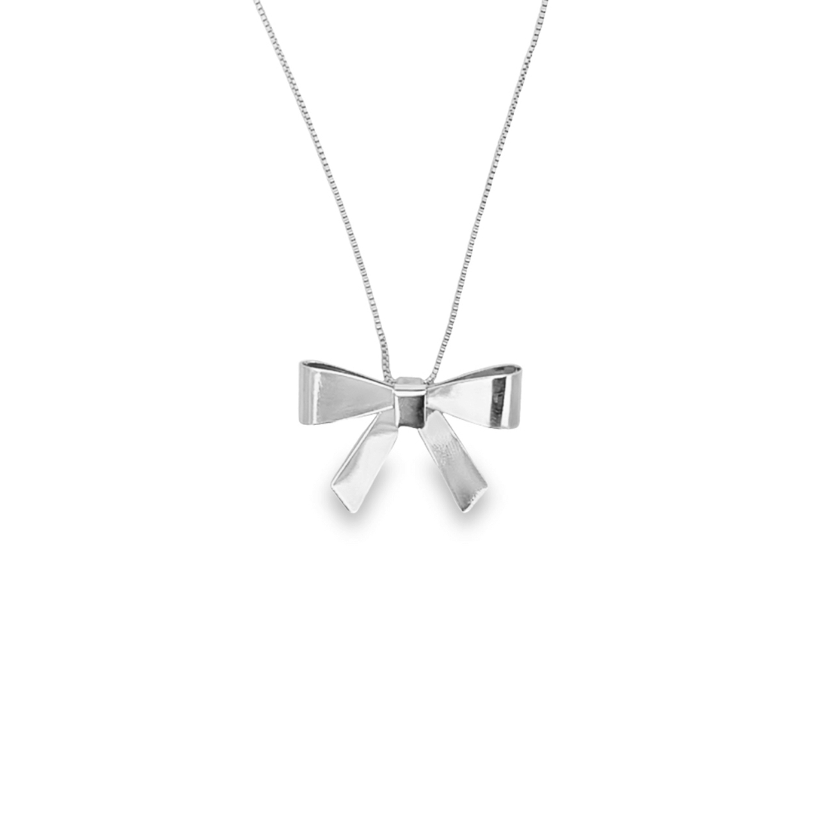 A delicate silver necklace features a charming bow-shaped pendant hanging from a fine chain against a white background.