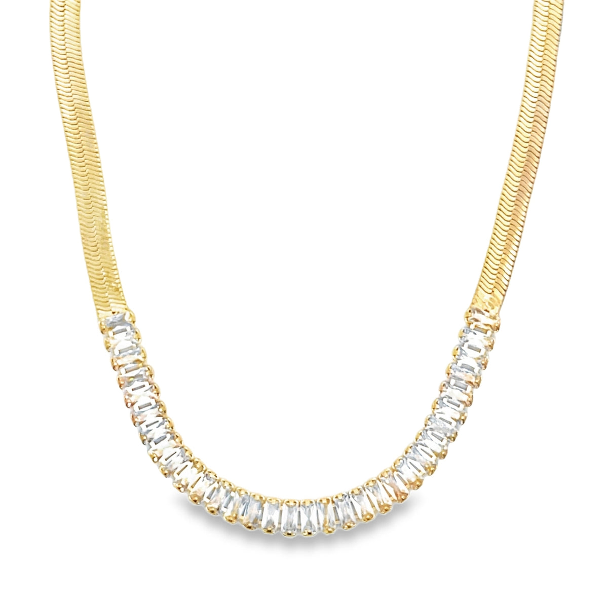 A gold herringbone chain necklace features a dazzling crescent of rectangular baguette-cut cubic zirconia stones nestled along the front.