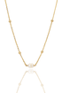 A delicate gold chain necklace features small metal beads and a central twin pearl pendant against a clean white background.