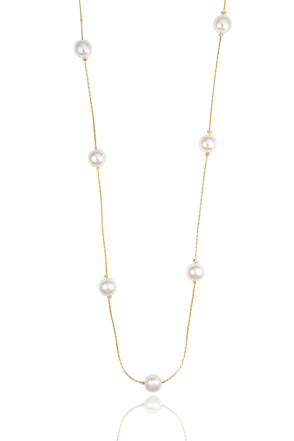A delicate gold chain necklace with alternating white pearls dangles against a clean white background.