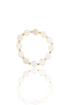 A beaded bracelet made of round white mother-of-pearl stones separated by small gold square spacers rests on a reflective white surface.