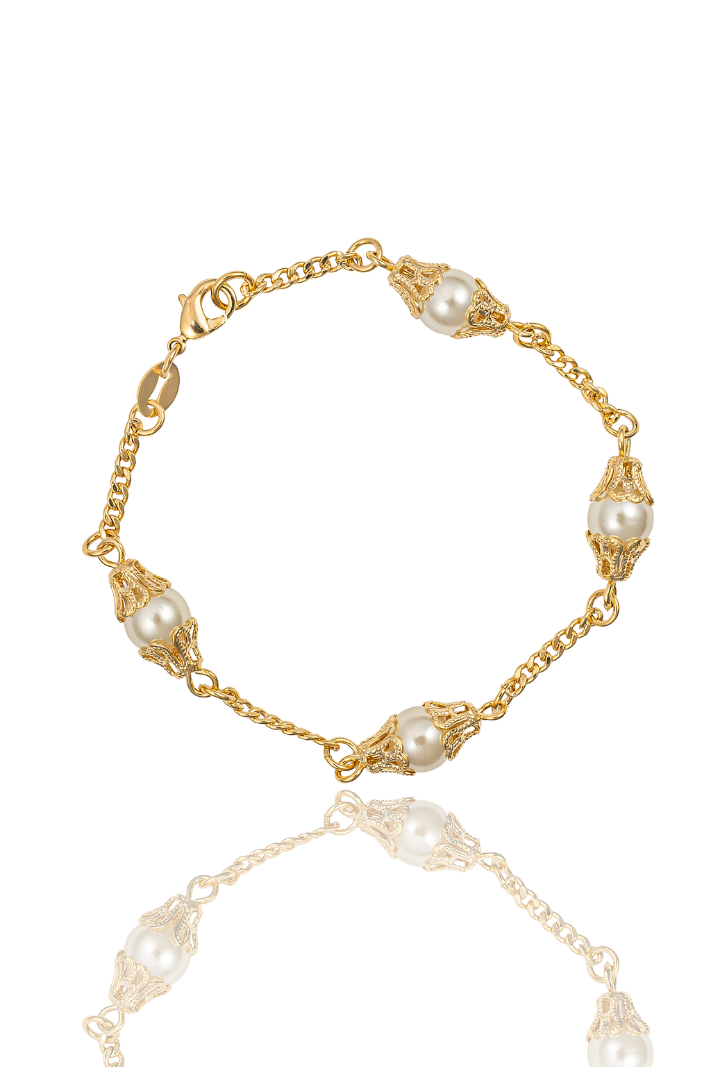 A delicate gold chain bracelet features ornate filigree settings holding lustrous faux pearls, displayed against a clean white background.