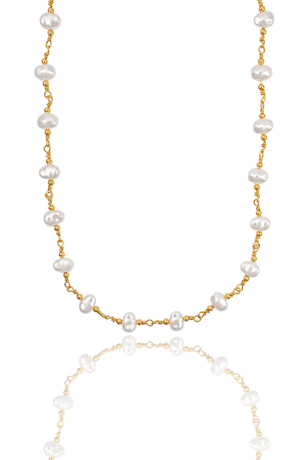 A delicate gold chain necklace featuring spaced freshwater pearls hangs against a clean white background with its reflection visible below.