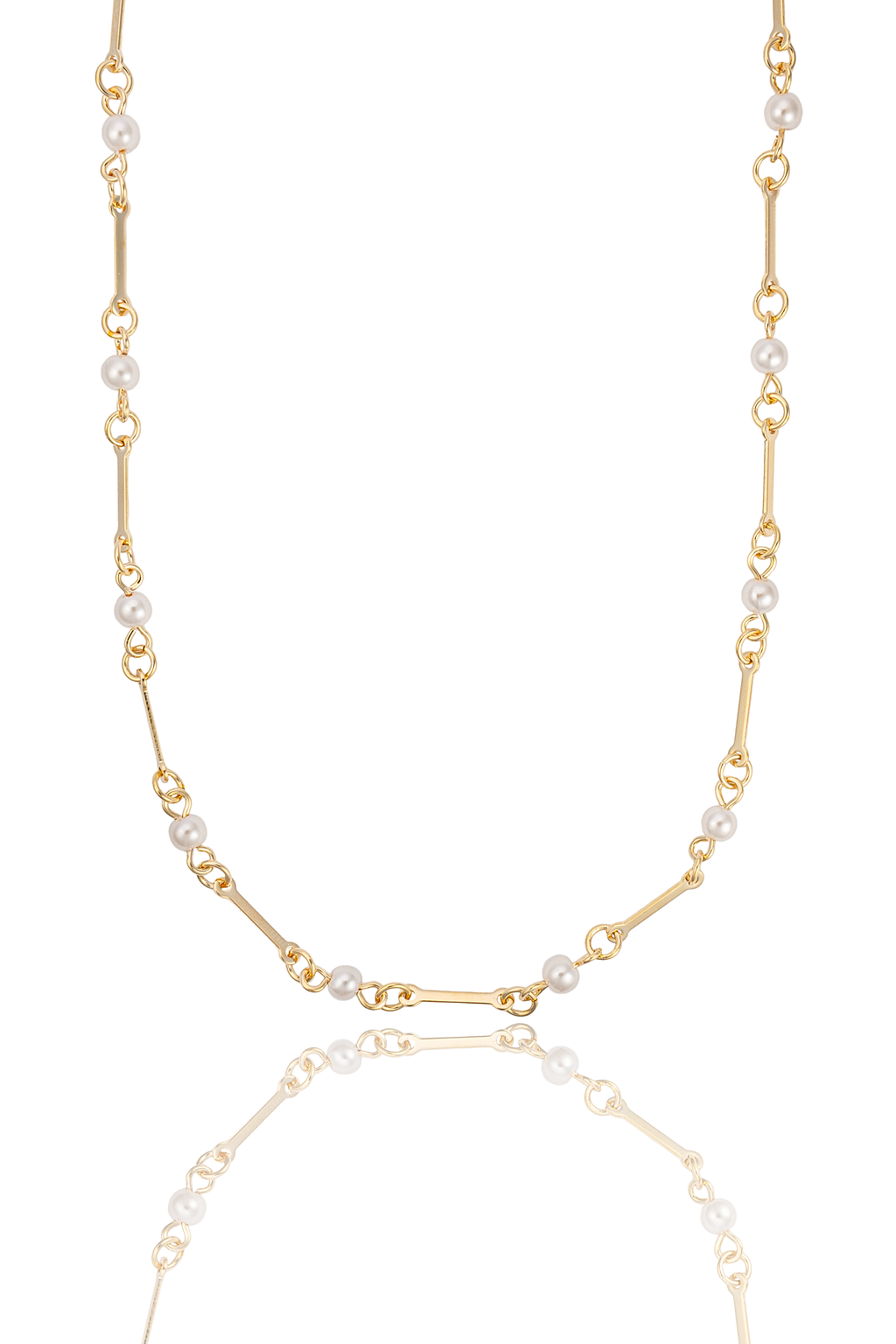 A delicate gold chain necklace interspersed with small white pearls is displayed against a clean white background, casting a soft reflection below.