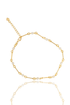 A delicate gold chain bracelet features alternating metallic bars and small white pearls against a clean white background.