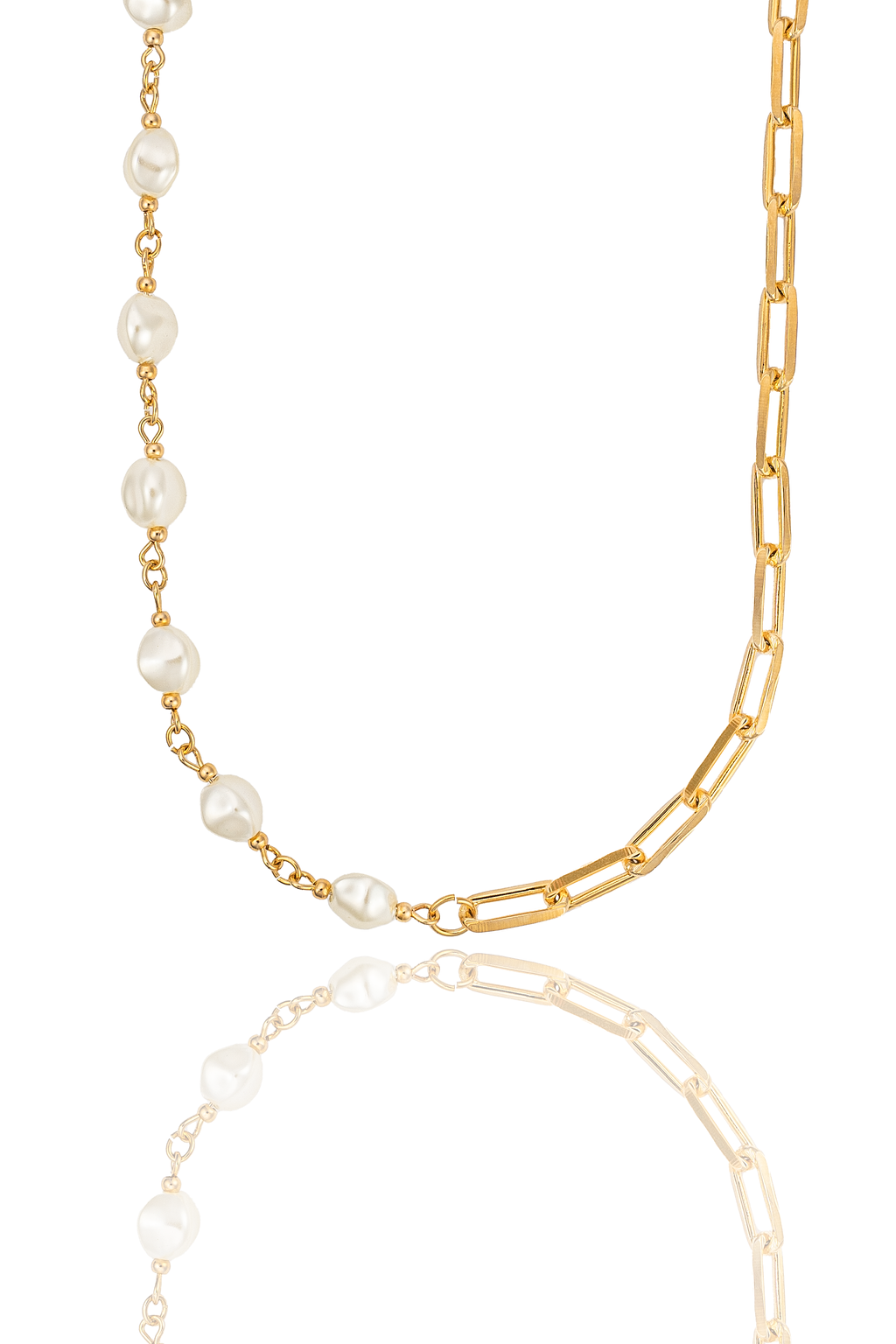 A gold-plated paperclip chain necklace features a section of baroque pearls on a white reflective surface.