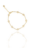 A gold star bracelet paved with sparkling cubic zirconia crystals rests against a white background with a subtle reflection.