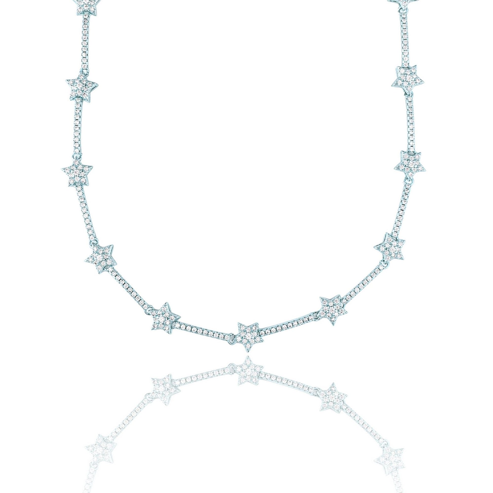 A delicate silver diamond star tennis necklace sparkles against a clean white background with its reflection below.