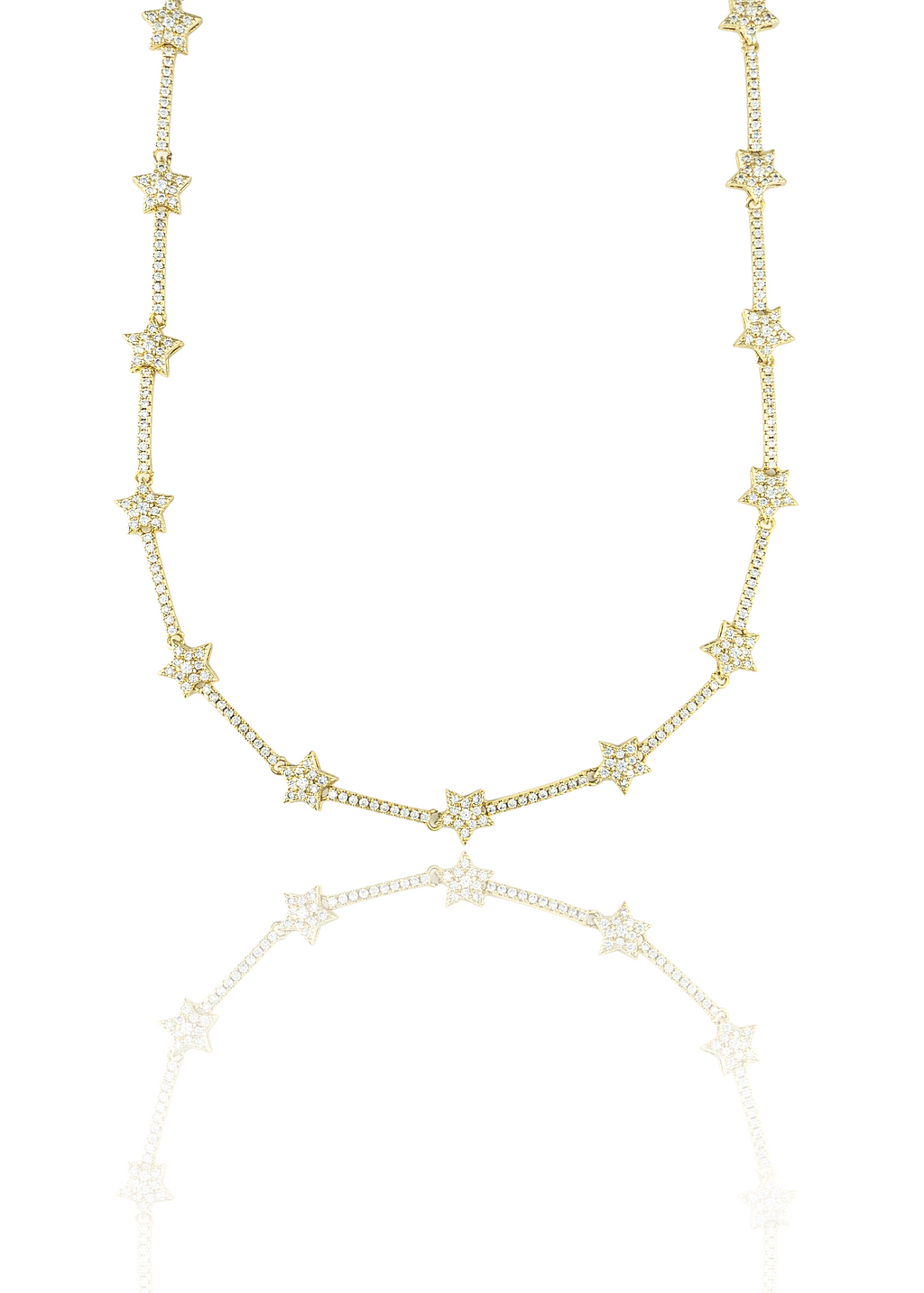 A gold diamond-encrusted star necklace sparkles against a reflective white surface.