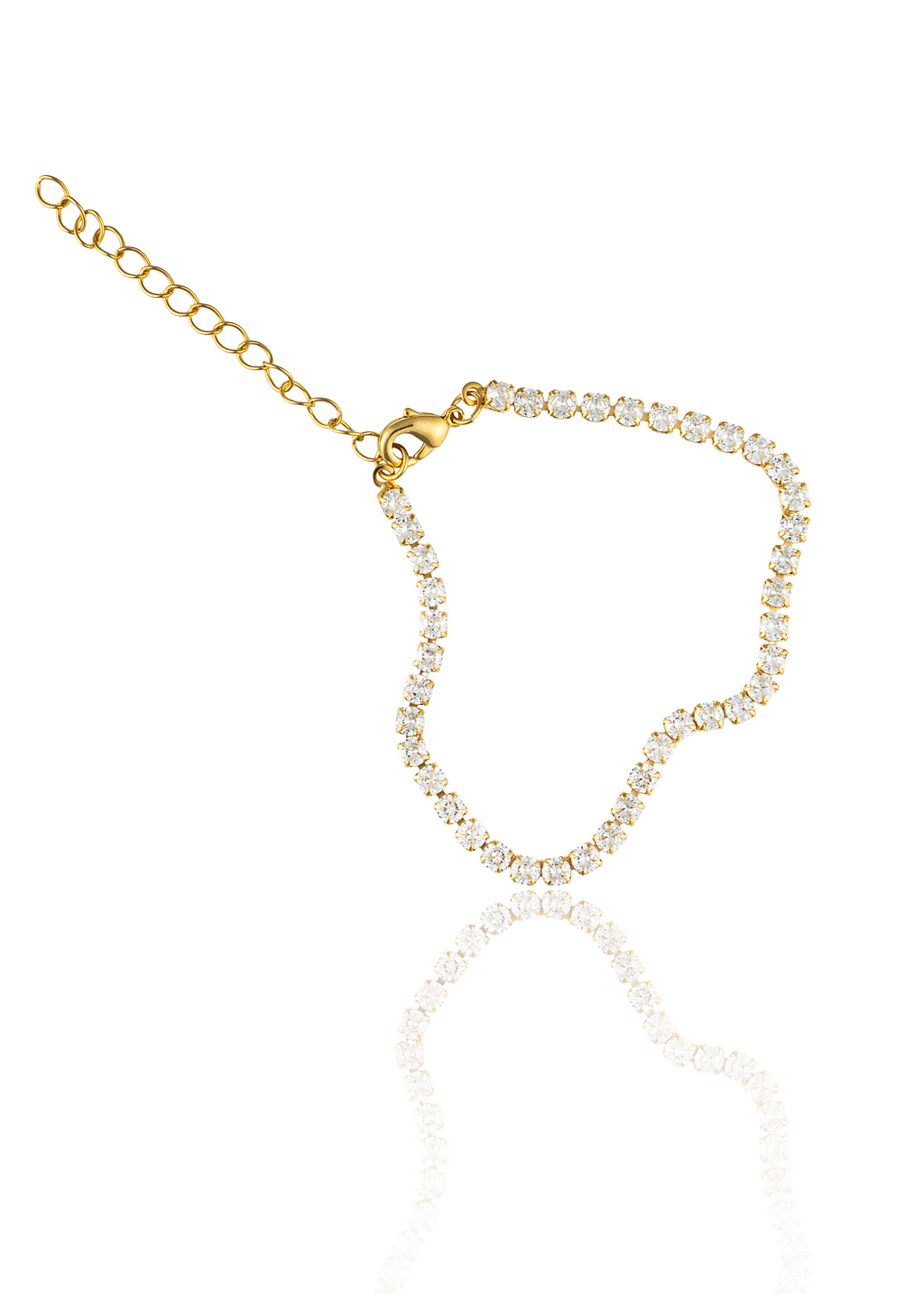 A delicate gold tennis bracelet encrusted with sparkling cubic zirconia stones is displayed against a clean white background with a subtle reflection.