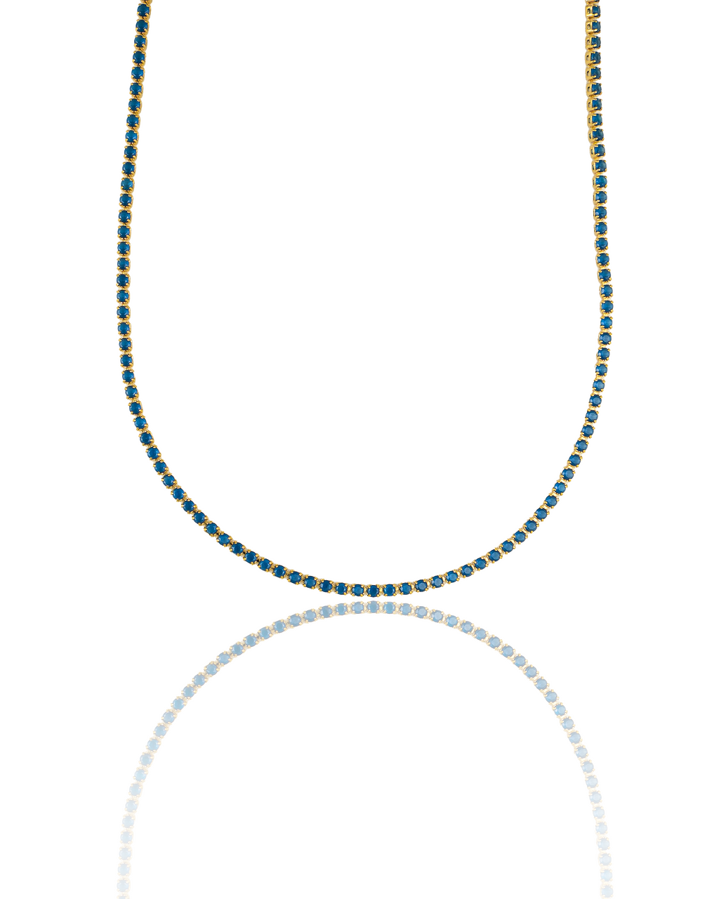 A gold tennis necklace featuring vibrant blue stones curves gracefully against a white background with a subtle reflection below.