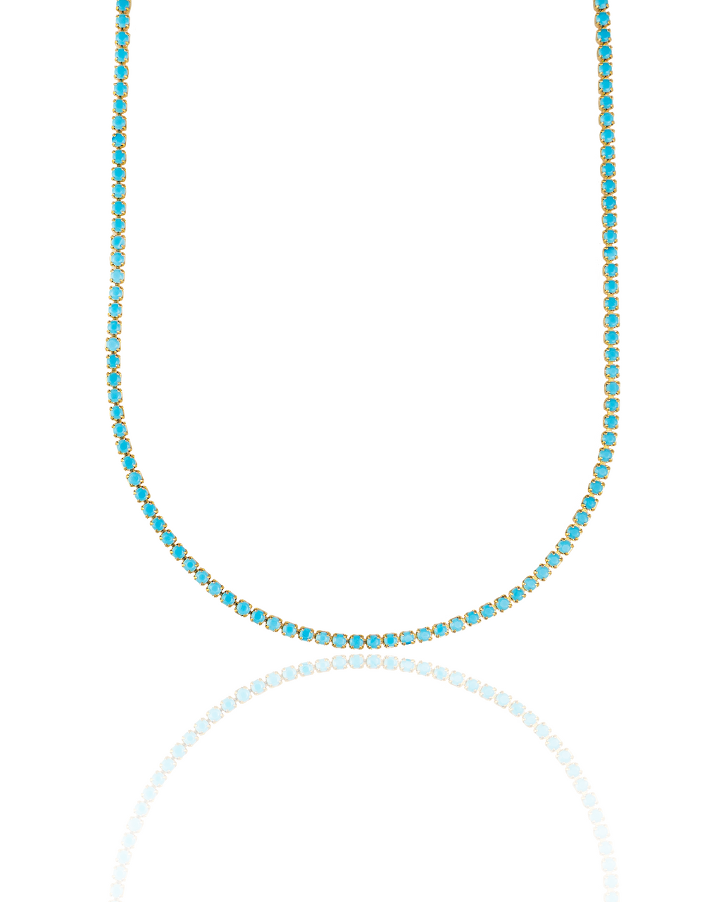 A gold tennis necklace featuring vibrant turquoise stones drapes against a clean white background.