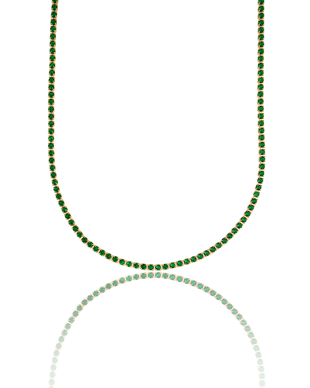 A luxurious gold tennis necklace sparkles with vibrant green emerald stones against a clean white background, reflecting its brilliance below.