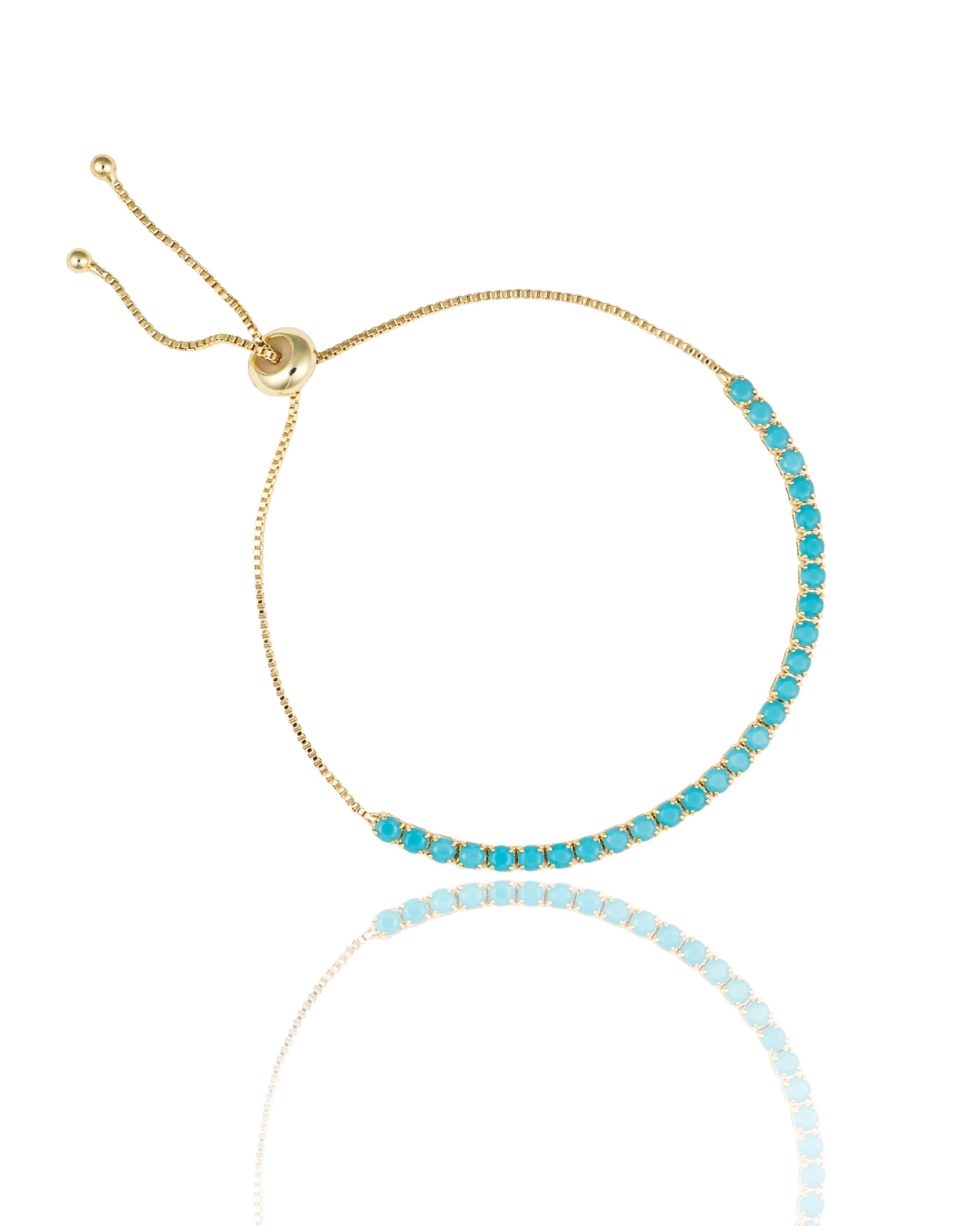 A delicate gold slider bracelet features a sparkling row of vibrant turquoise gemstones.