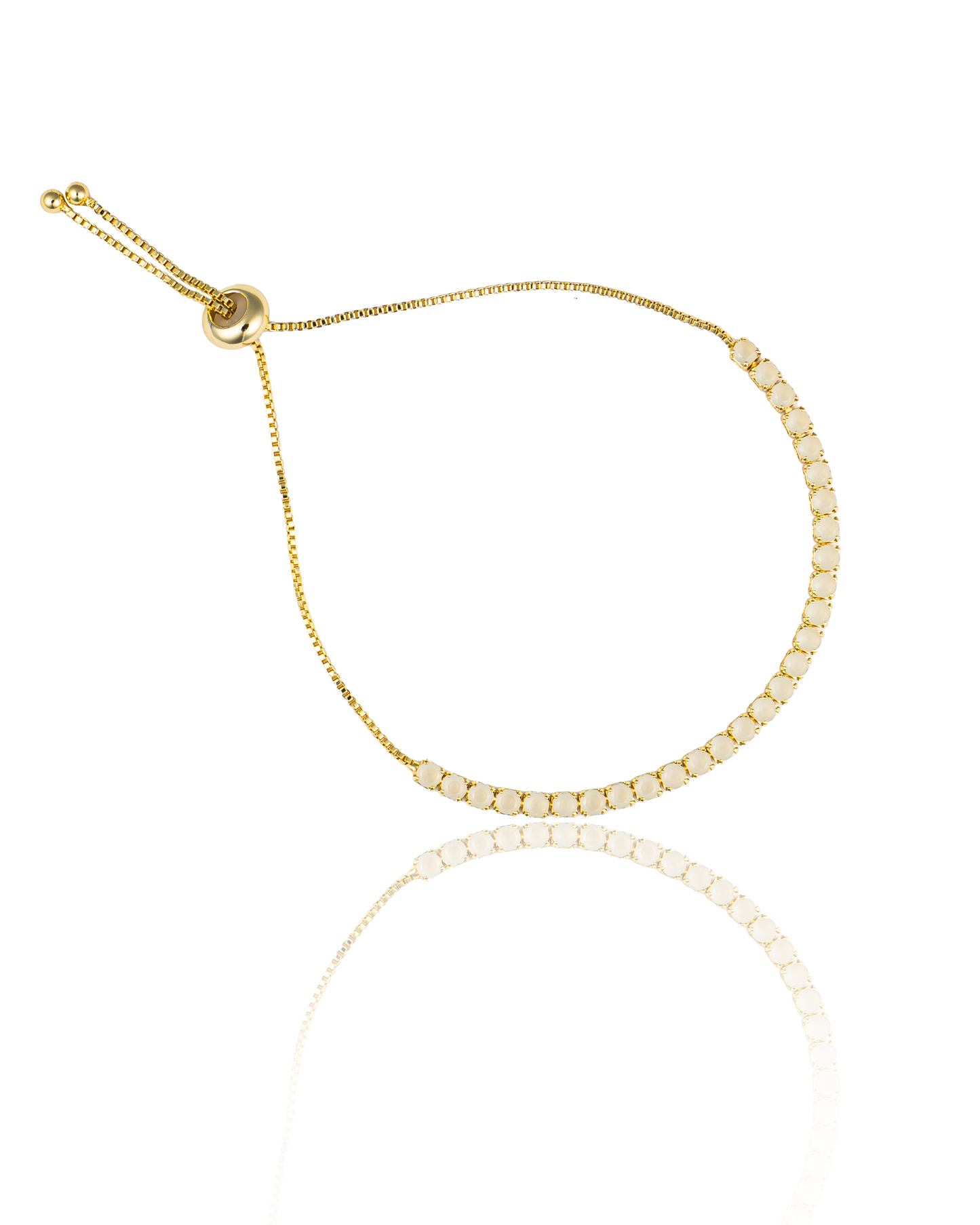A gold-plated adjustable tennis bracelet features a line of round white gemstones and an intricate box chain with a sliding closure.