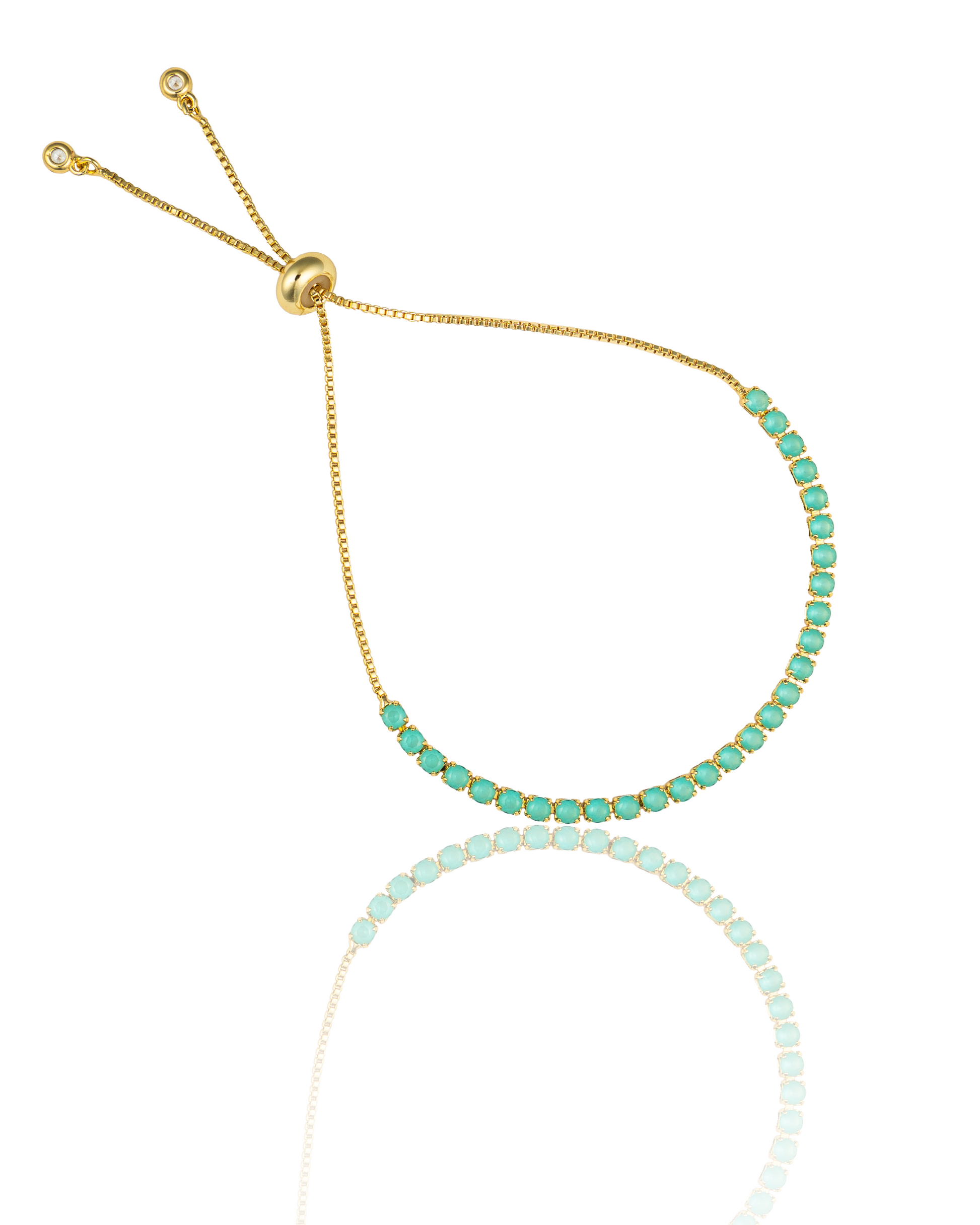 A delicate gold adjustable slider bracelet displays a vibrant row of round turquoise gemstones against a white background.