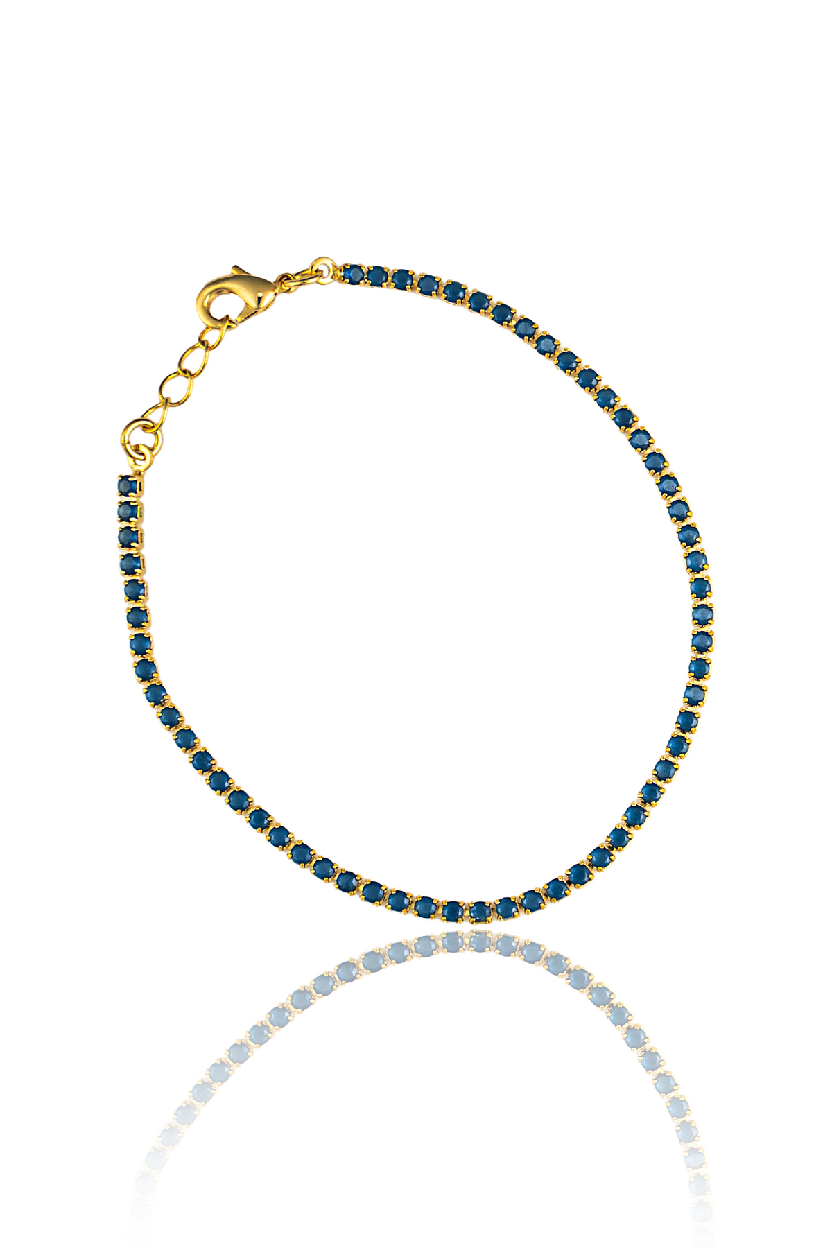 A delicate gold tennis bracelet features a continuous line of vibrant blue round-cut stones.