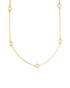A delicate gold chain necklace features sparkling bezel-set crystals spaced evenly along its length.