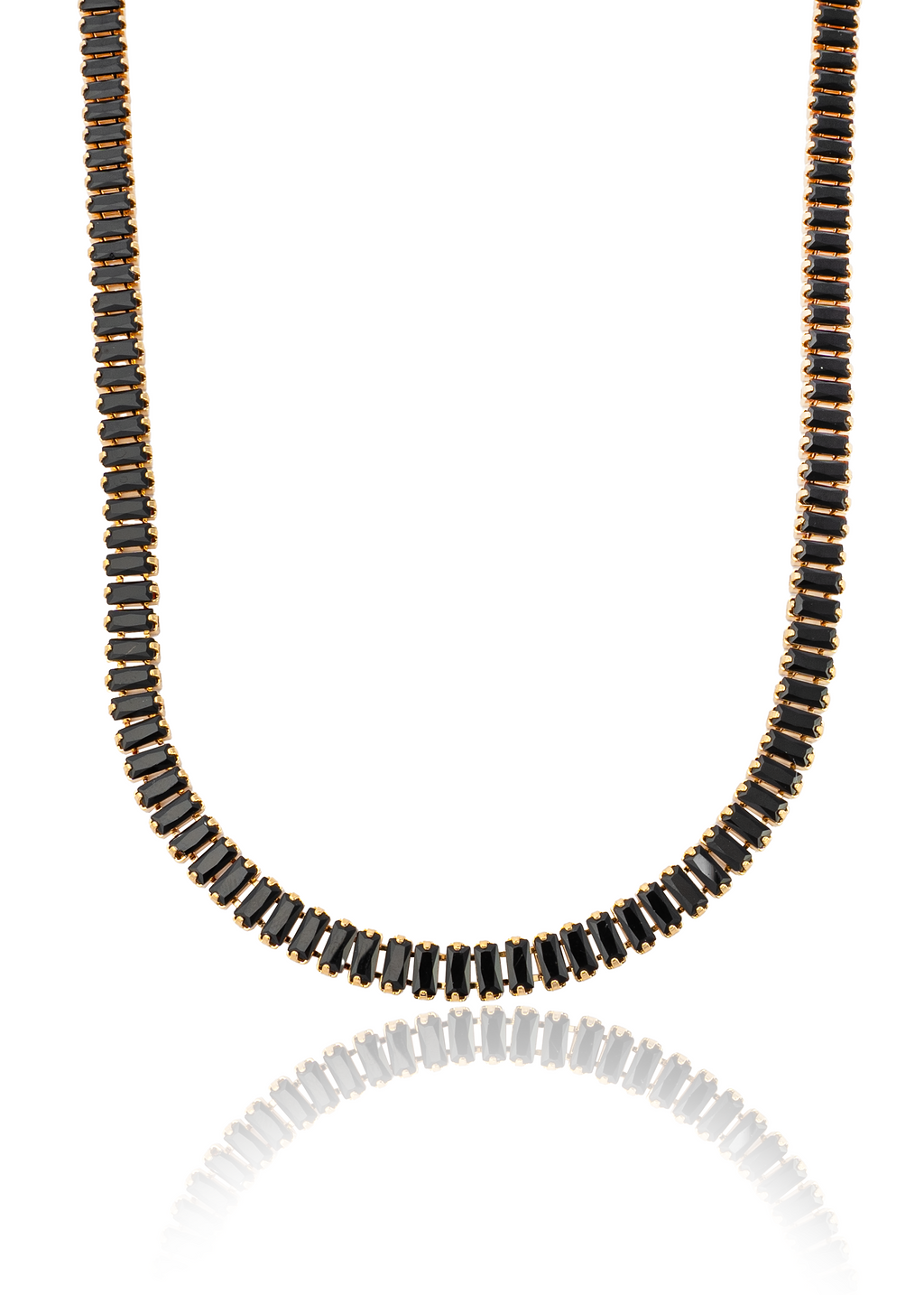 A gold tennis necklace features a continuous strand of baguette-cut black stones against a clean white background.