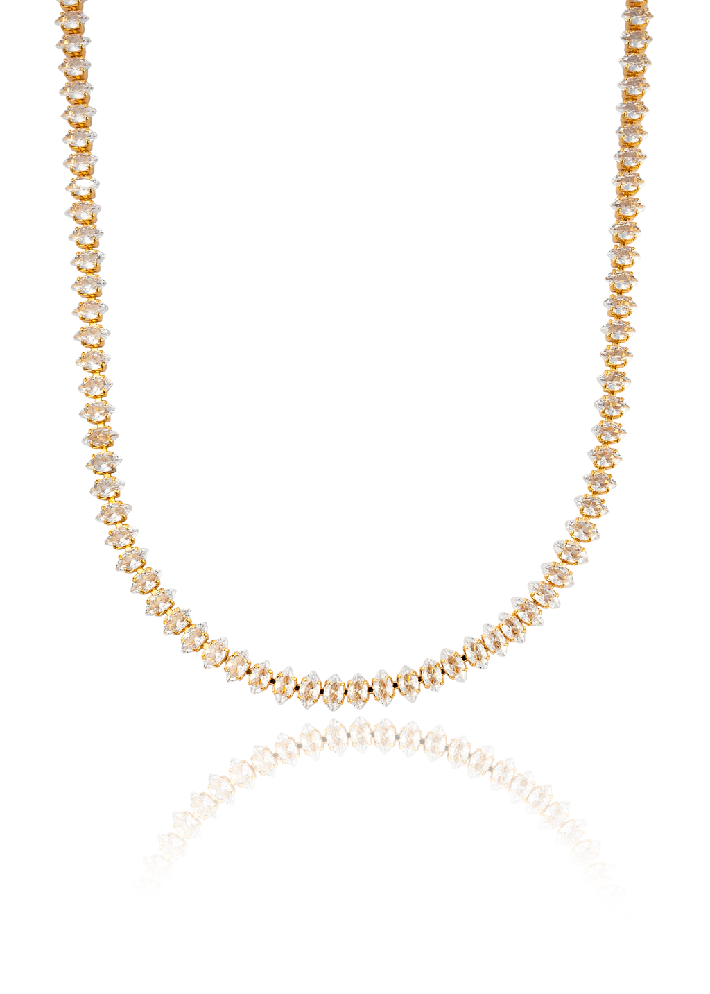 A gold tennis necklace featuring sparkling marquise-cut diamonds rests against a clean white background, reflecting softly below.