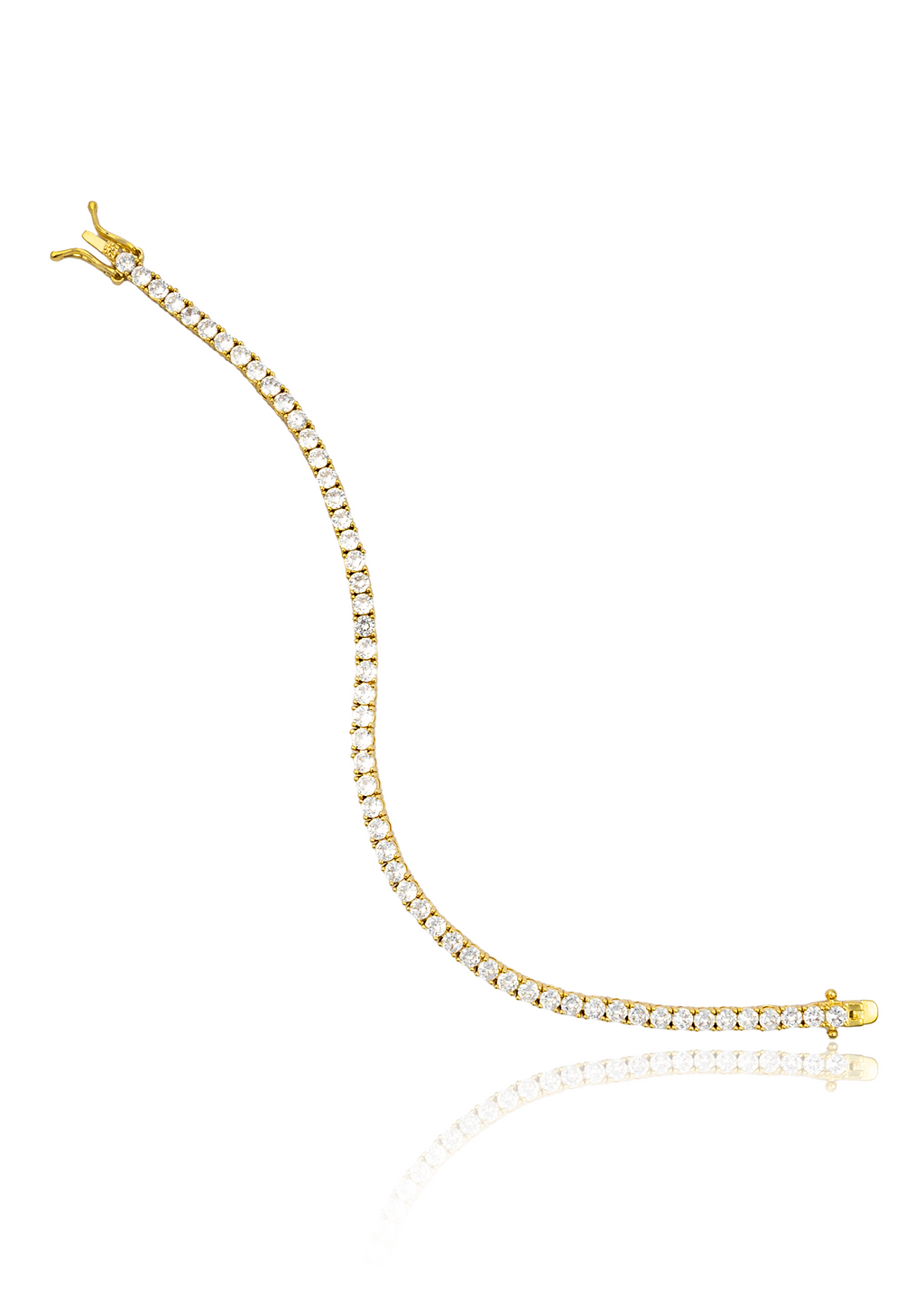 A delicate gold tennis bracelet set with sparkling cubic zirconia stones curves gracefully on a white reflective surface.