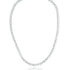 A sparkling diamond tennis necklace rests in a circular display against a clean white background.