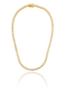 A sparkling gold tennis necklace features square-cut cubic zirconia stones and rests in a circular display with a clear reflection below.
