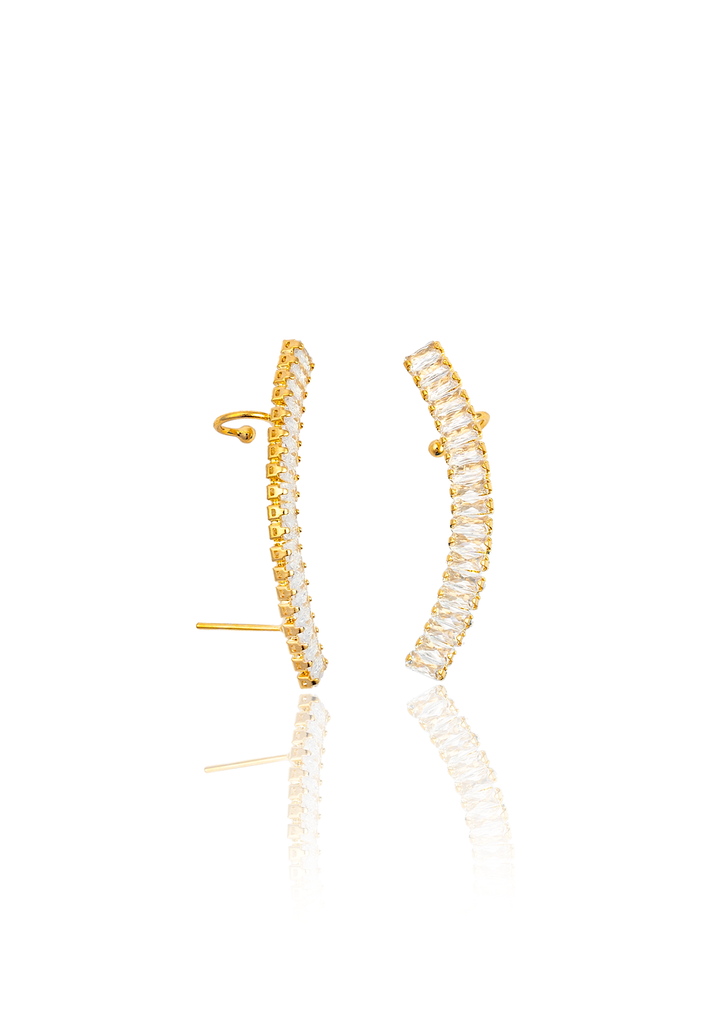 A pair of elegant gold ear cuffs features a curved row of sparkling baguette-cut white crystals against a clean white background.