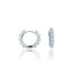 A pair of silver huggie hoop earrings featuring pavé-set stones and edgy spikes displayed on a reflective white surface.