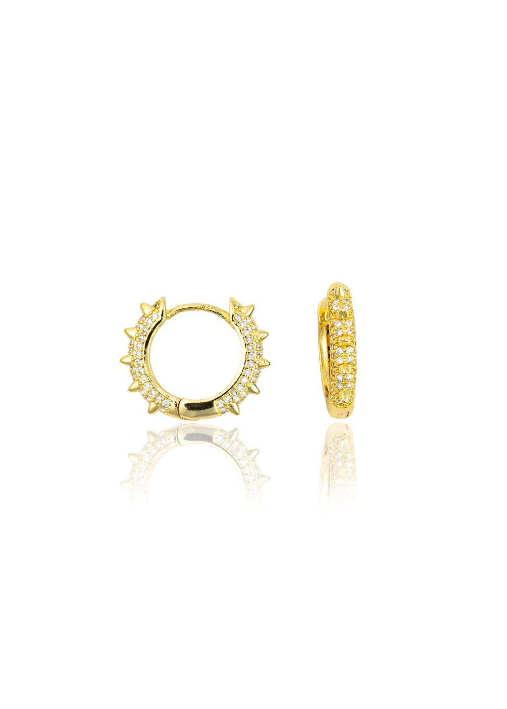 A pair of gold huggie hoop earrings featuring pavé-set cubic zirconia stones and edgy spike details rests against a clean white background.