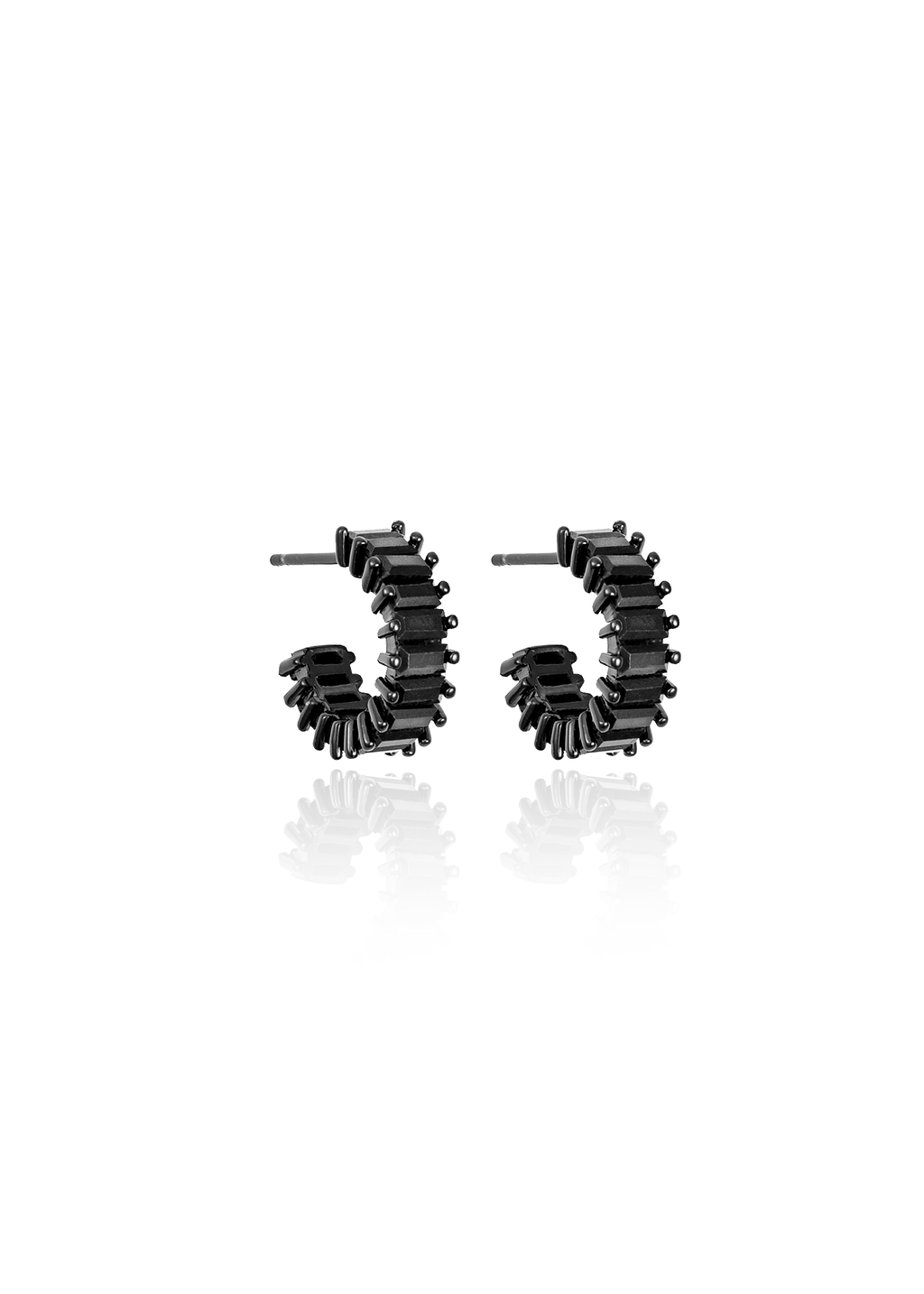 A pair of edgy black huggie hoop earrings featuring a textured, spike-studded design rest against a clean white background.