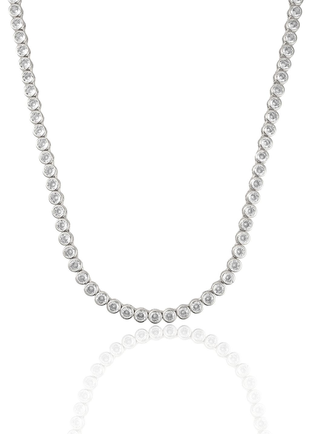 A dazzling bezel-set diamond tennis necklace drapes gracefully against a clean white background, reflecting its brilliance below.