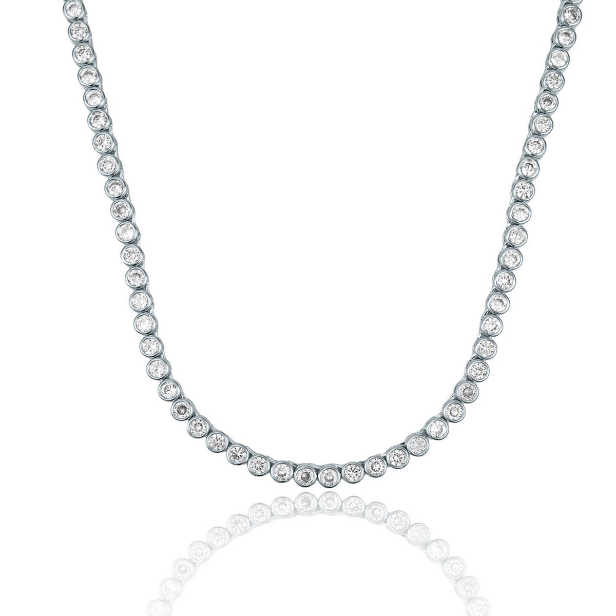 A sparkling bezel-set diamond tennis necklace rests against a clean white background with a subtle reflection underneath.