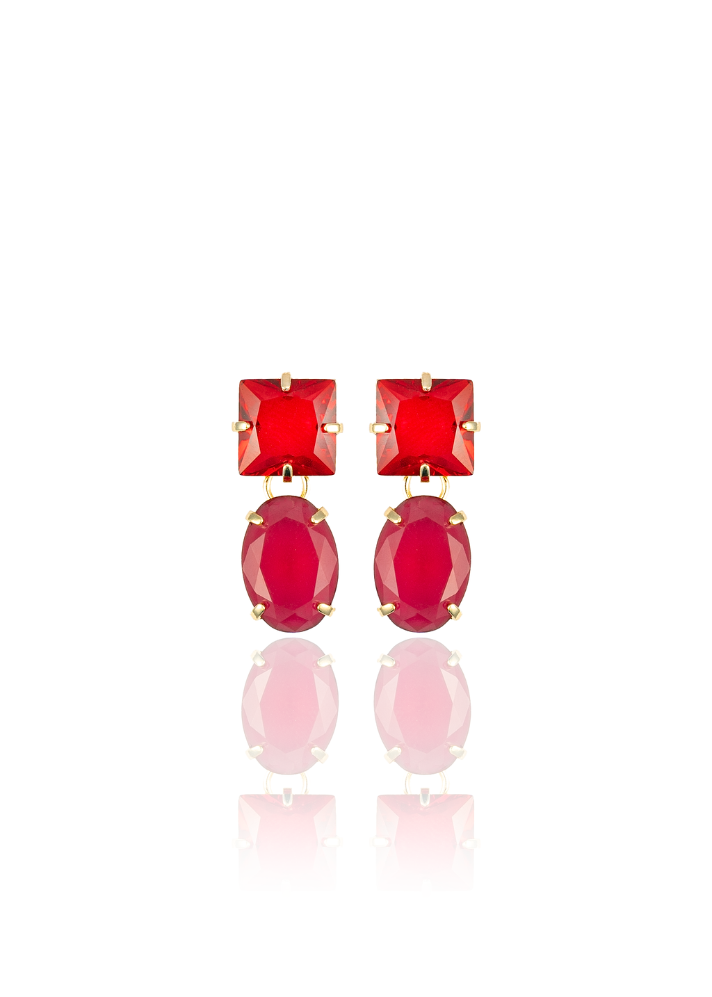 A pair of gold-plated drop earrings features vibrant red square and oval crystals against a clean white background.