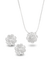 A matching silver diamond jewelry set displays a delicate pendant necklace and a pair of sparkling floral stud earrings.