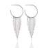 A pair of silver hoop earrings features cascading fringe dangles on a white background.