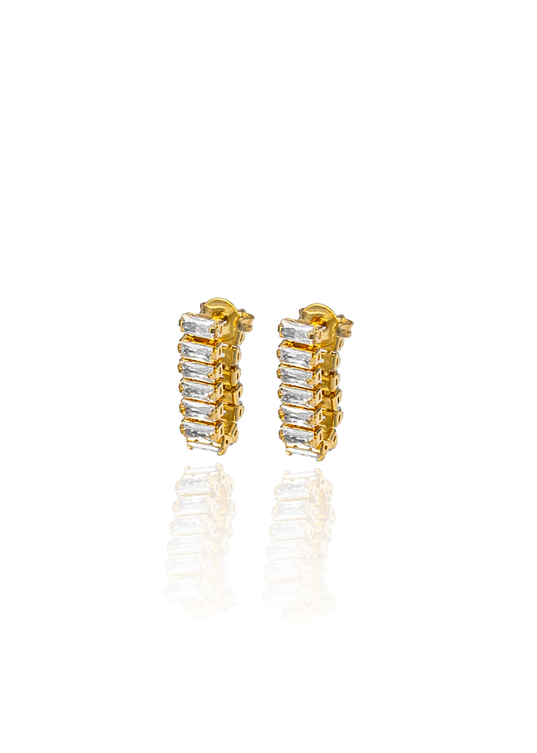 huggie earrings with blue baguette cubic zirconia stones. Modern crystal huggies with a sleek vertical design.