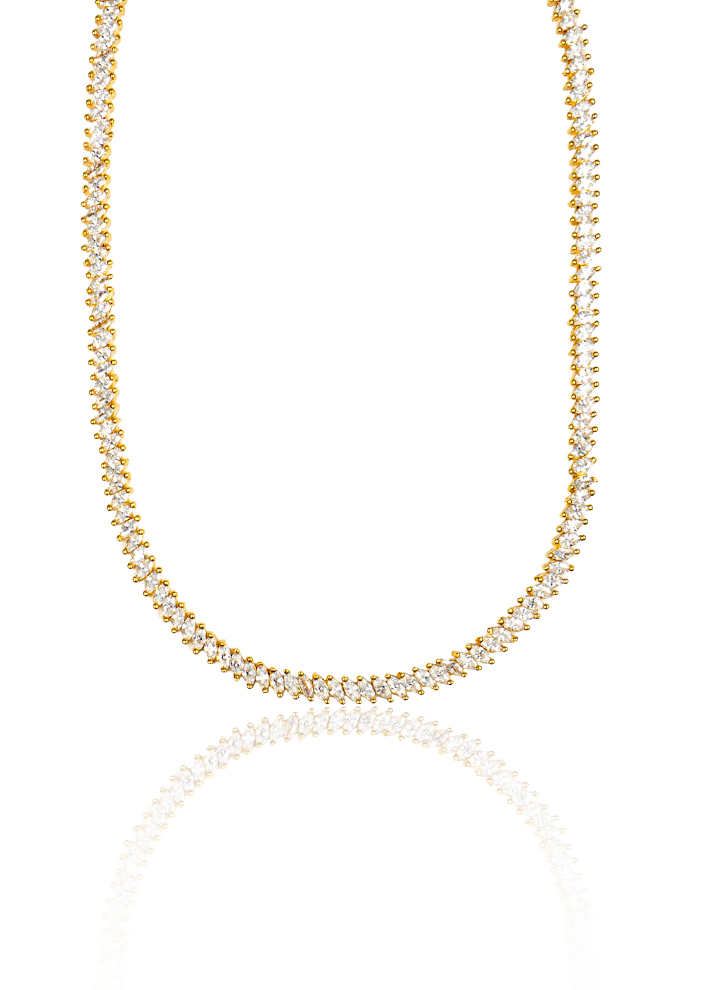 A gleaming gold diamond tennis necklace sparkles against a clean white background, reflecting softly below.