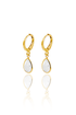 A pair of elegant gold hoop earrings features dangling teardrop-shaped white crystal charms against a clean white background.